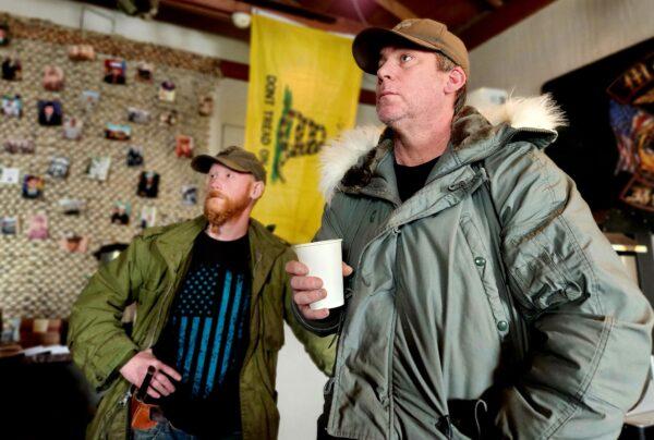 U.S. Army veteran Rick Northrop (L) and Tom West, co-founder of Operation: Transition Outside the Wire watch a video on post-traumatic stress disorder on Jan. 16, 2023. (Allan Stein/The Epoch Times)