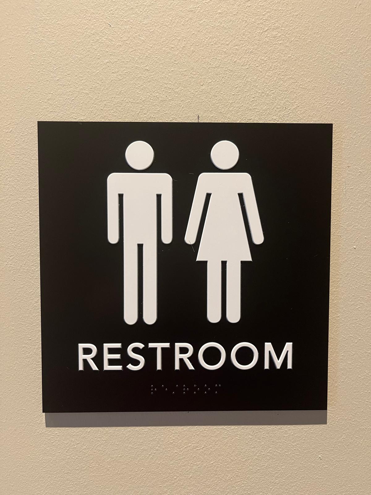 A sign on a single-person bathroom at a Starbucks in Gainesville, Fla., on Jan. 23, 2023, indicates it's offered for male and female users, instead of being designated by gender. (Nanette Holt/The Epoch Times)