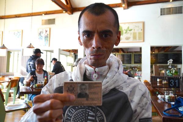 Former U.S. Marine Sgt. Brian Alvarado displays his military service card in Brentwood, Calif., on Jan. 16, 2023. (Allan Stein/The Epoch Times)