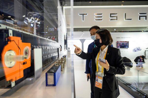People visit the Tesla stand at the China International Import Expo (CIIE) in Shanghai on Nov. 5, 2021. (STR/AFP via Getty Images)