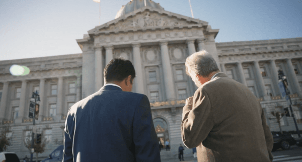 Tony Hall, a former member of the San Francisco Board of Supervisors, speaks with Siyamak Khorrami in the documentary “California's Crime Wave.” (Hau Nguyen/The Epoch Times)