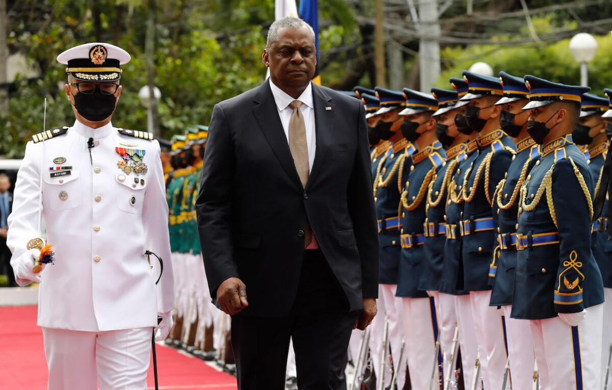 U.S. Defense Secretary Lloyd Austin (R) walks past military guards during arrival honors at the Department of National Defense in Camp Aguinaldo military camp in Quezon City, Manila, Philippines, on Feb. 2, 2023. (Rolex Delapena-Pool/Getty Images)