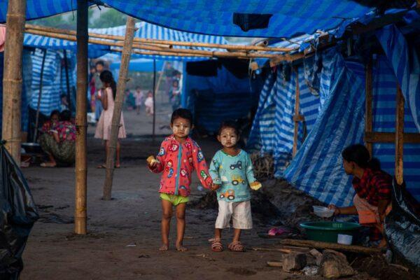 This photo taken on Feb. 14, 2022, shows Burmese refugee children who fled a surge in violence as the military cracks down on rebel groups, looking on at a camp in Nawphewlawl near the Burma-Thailand border in Kayin state. (STR/AFP via Getty Images)