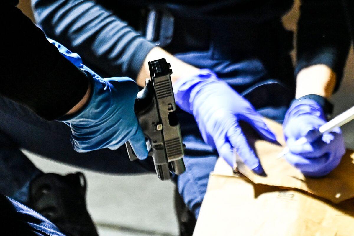 Police officers collect evidence at the scene of a shooting that occurred during the Krewe of Bacchus parade in New Orleans, on Feb. 19, 2023. (Chandan Khanna/AFP/Getty Images)