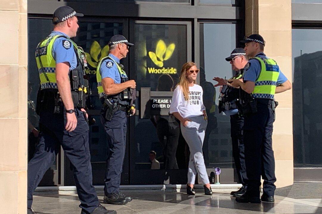 Protester Paints Woodside Energy Logo on Western Australia Parliament