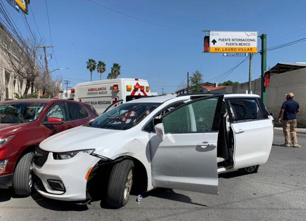 A member of the Mexican security forces stands next to a white minivan with North Carolina plates and several bullet holes, at the crime scene where gunmen kidnapped four U.S. citizens who crossed into Mexico from Texas, on March 3, 2023. (AP Photo)
