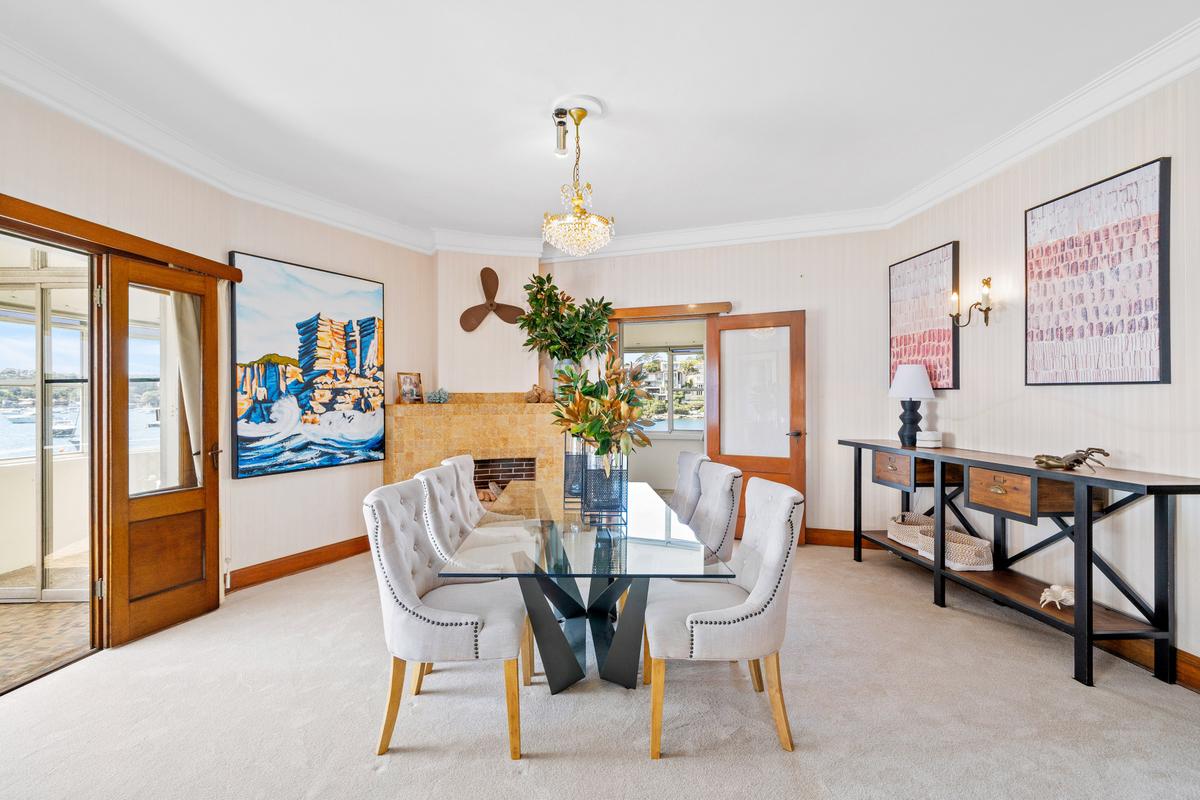 The formal dining room exudes simple elegance; a door leads to the adjacent kitchen. (Courtesy of Sydney Sotheby's International Realty)