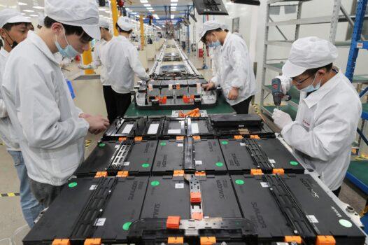 Workers at a factory for Xinwangda Electric Vehicle Battery Co., which makes lithium batteries for electric cars and other uses, in Nanjing in China's eastern Jiangsu Province, on March 12, 2021. (STR/AFP via Getty Images)
