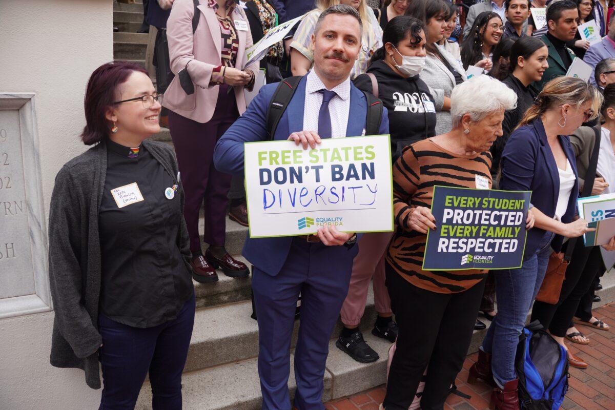 A demonstrator at the Equality Florida rally at the Florida Capitol in Tallahassee holds a sign that says "Free States Don't Ban Diversity" on March 13, 2023. (Dan M. Berger/The Epoch Times)