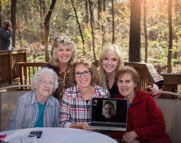 The author (rightmost) with her sisters, brother (on laptop screen), and mother (leftmost). (Courtesy of Judy Walters)