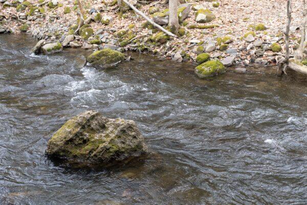 A brook near the site of the future veteran village on Main Street in Port Jervis, N.Y., on March 17, 2023. (Cara Ding/The Epoch Times)