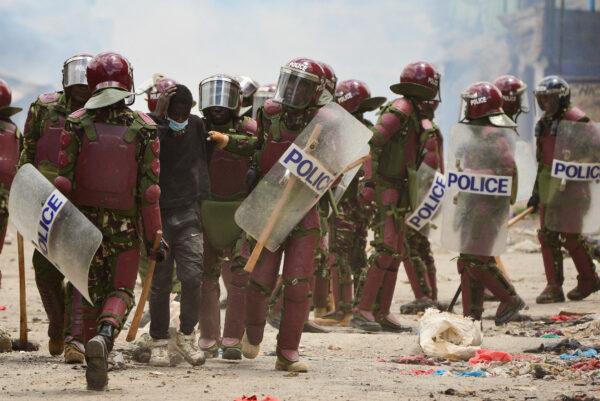 Riot police officers detain a supporter of Kenya's opposition leader Raila Odinga of the Azimio La Umoja (Declaration of Unity) One Kenya Alliance, as they participate in a nationwide protest over cost of living and President William Ruto's government in Mathare settlement of Nairobi, Kenya, on March 30, 2023. (John Muchucha/Reuters)