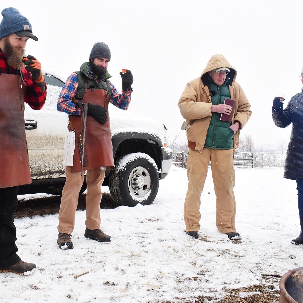 Poet, novelist, and environmentalist Wendell Berry (R) attends a hog butchering held by Hand Hewn Farm in the winter of 2022. (Courtesy of Hand Hewn Farm)