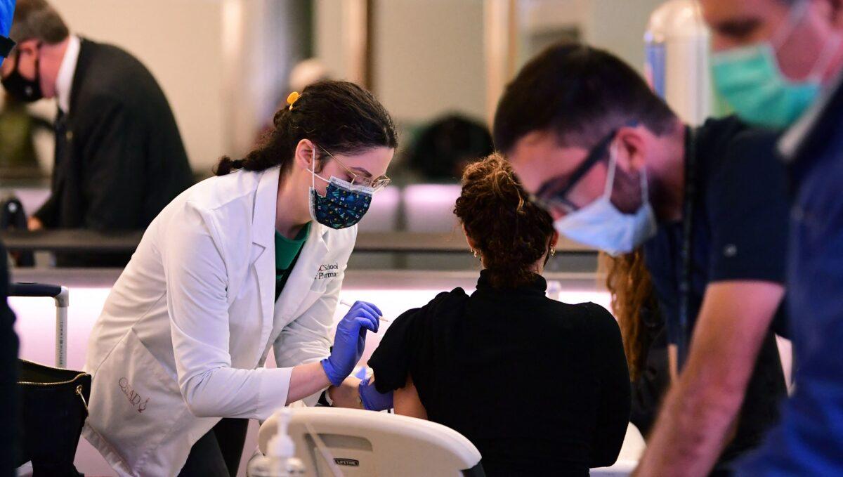 A person receives a COVID-19 vaccine at Los Angeles International Airport in Los Angeles, Calif., on Dec. 22, 2021. (Frederic J. Brown/AFP via Getty Images)