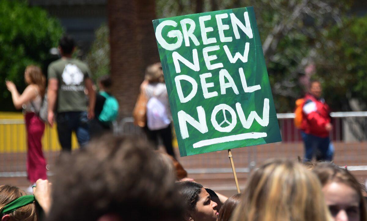 Climate change activists hold signs while taking part in a climate protest in Los Angeles on May 24, 2019. (Frederic J. Brown/AFP via Getty Images)
