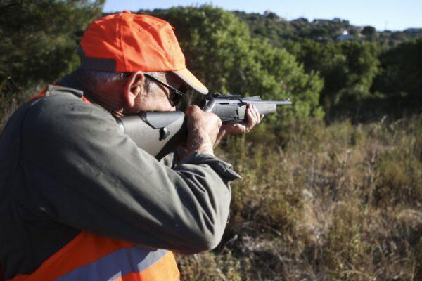 A hunter holds his gun during a boar hunt in Pietrosella on the French Mediterranean island of Corsica on Aug. 15, 2020. (Pascal Pochard-Casabianca/AFP via Getty Images)