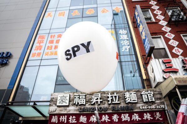 A balloon is held at a press conference and rally in front of the America ChangLe Association, highlighting Beijing's transnational repression in New York City on Feb. 25, 2023. A now-closed overseas Chinese police station had been located inside the building. (Samira Bouaou/The Epoch Times)
