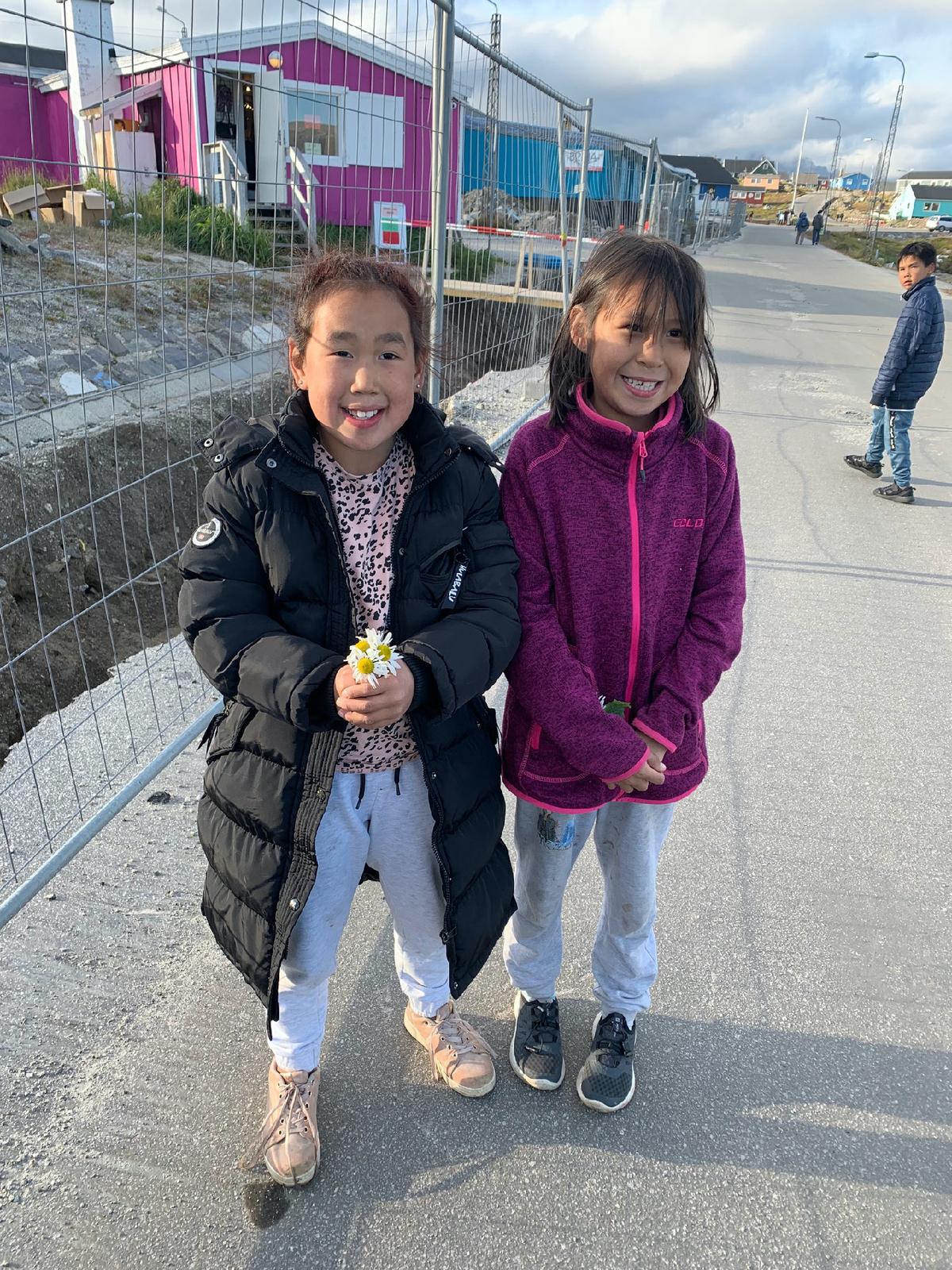 Native girls greet passengers from a cruise ship in Nanortalik, Greenland. (Photo courtesy of Sharon Whitley Larsen)