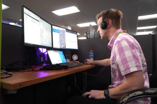 Solari Crisis and Human Services crisis call taker Robbie logs into the system on April 13, 2023. (Allan Stein/The Epoch Times)