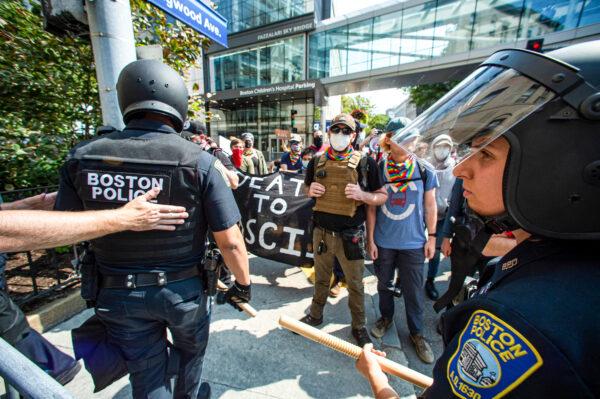 Police face pro-transgender protesters outside of Boston Children's Hospital in Boston, Mass., on Sept. 18, 2022. (JOSEPH PREZIOSO/AFP via Getty Images)