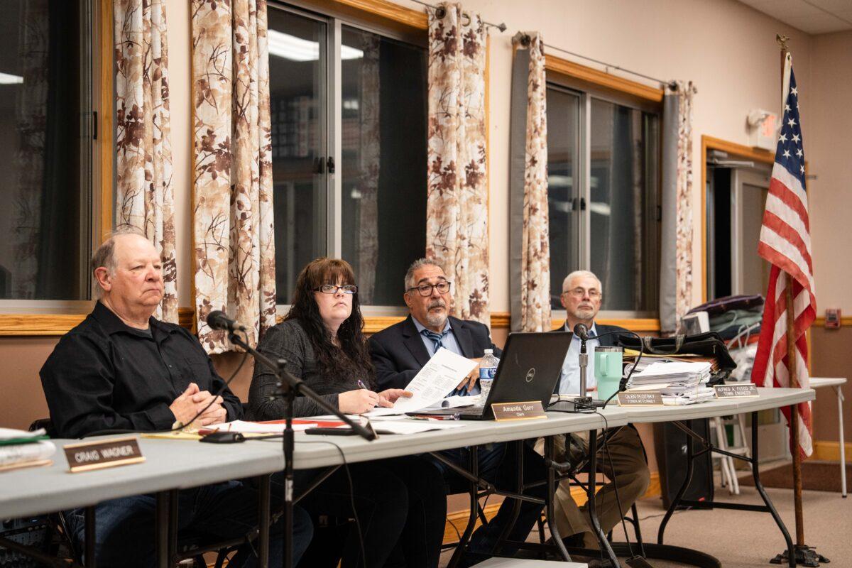 (L–R) Chairman of the Planning Board Robert Vicaretti, clerk Amanda Gorr, town attorney Glen Plotsky, and town engineer Alfred Fusco listen to residents at a public hearing on New Century's proposed development, at the Town of Deerpark Senior Center in Huguenot, N.Y., on April 26, 2023. (Samira Bouaou/The Epoch Times)