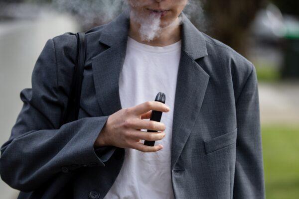 A woman is seen vaping in Melbourne, Australia, on May 3, 2023. (AAP Image/Diego Fedele)