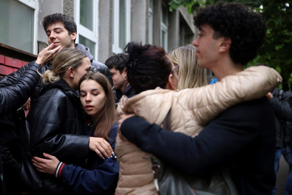 People mourn the victims near Vladislav Ribnikar school in Belgrade, Serbia, on May 4, 2023. (Armin Durgut/AP Photo)