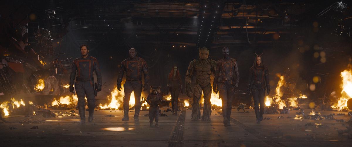 (L–R) Peter Quill (Chris Pratt), Drax (Dave Bautista), Rocket Racoon (voiced by Bradley Cooper), Gamora (Zoe Saldaña), Groot (voiced by Vin Diesel), Nebula (Karen Gillan), and Mantis (Pom Klementieff), leaving a set-piece in shambles, in "Guardians of the Galaxy Vol. 3." (Marvel Studios)