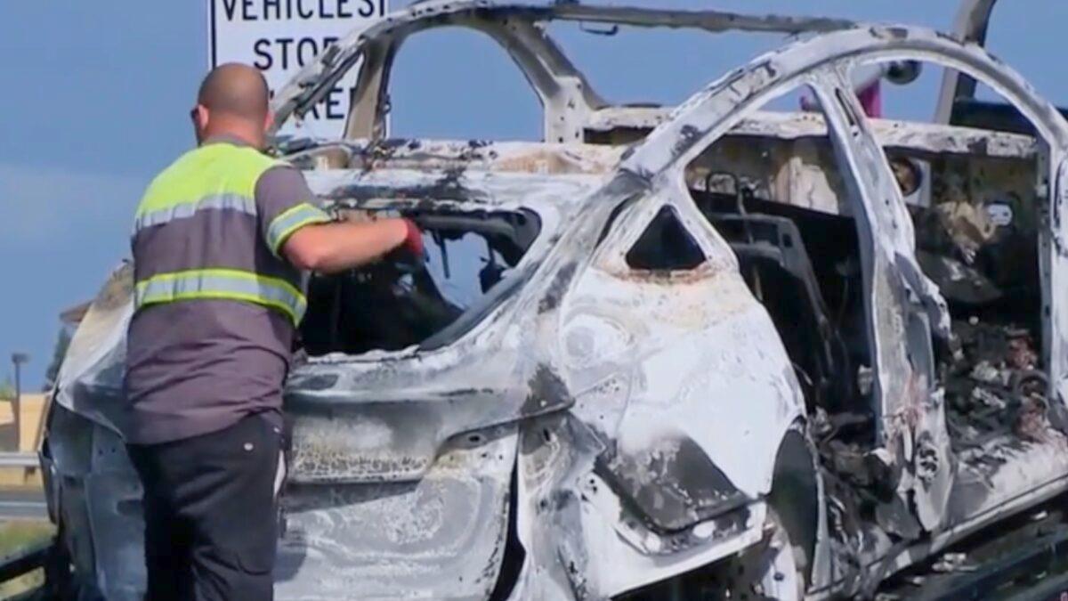 A tow truck taking away a burned Tesla after the electric vehicle caught fire on a California highway on May 6, 2023. (Courtesy of KCRA via CNN)