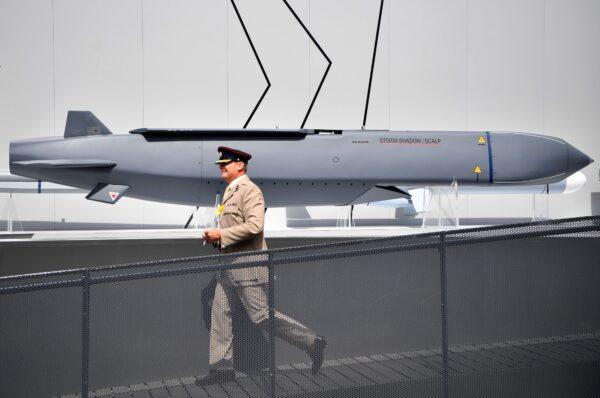 A member of the military walks past a MBDA Storm Shadow/Scalp missile at the Farnborough Airshow, southwest of London, on July 17, 2018. (Ben Stansall/AFP via Getty Images)