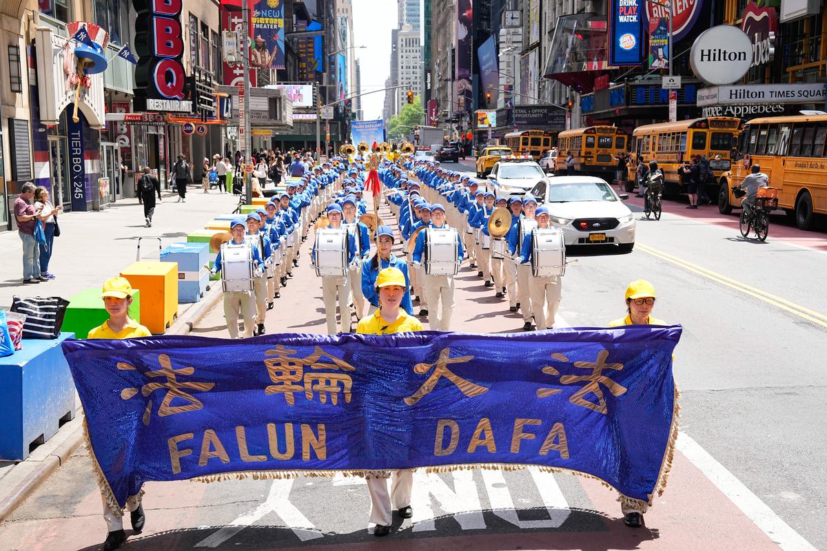 Falun Gong practitioners march in Manhattan to celebrate World Falun Dafa Day on May 12, 2023. (Larry Dye/The Epoch Times)
