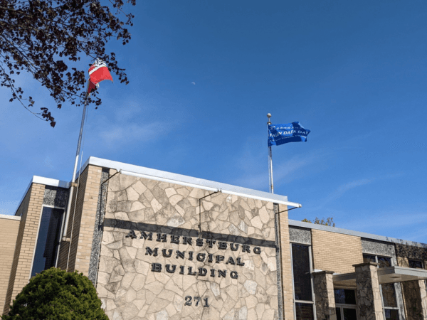 A Falun Dafa flag flies over the Amherstburg municipal building on April 30, 2023. (Courtesy of Falun Dafa Association of Canada)