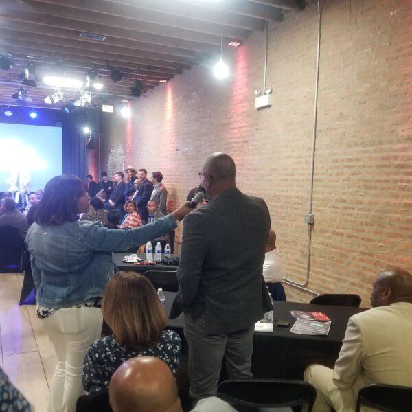 Kathy Barnette holds up the microphone for pastor Louis Reeves as he questions presidential hopeful Vivek Ramaswamy at an event in Chicago on May 19, 2023. (Nathan Worcester/The Epoch Times)