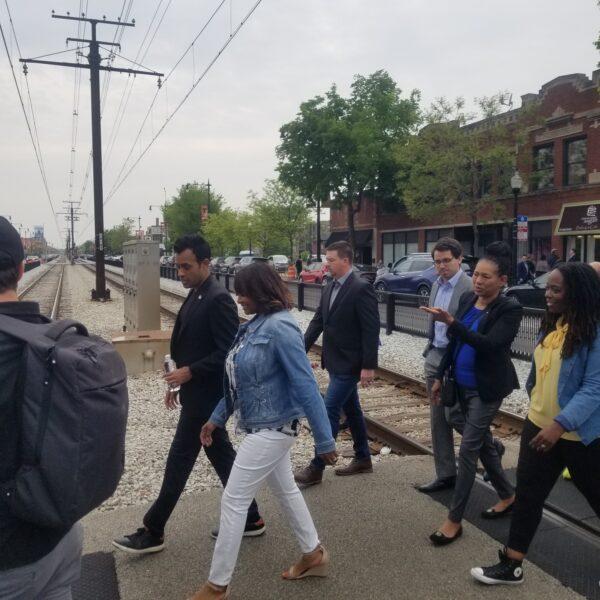 Vivek Ramaswamy and Kathy Barnette cross the Metra tracks in South Shore, Chicago, on May 19, 2023. Ramaswamy came to the neighborhood after protests over the planned arrival of hundreds of illegal immigrants to the community. (Nathan Worcester/The Epoch Times)