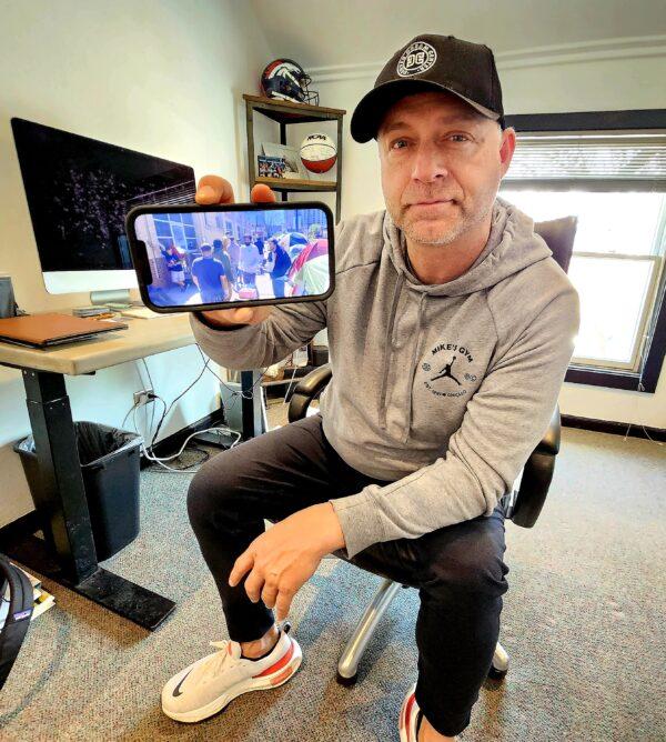 Pastor Brian Sederwall, director of the nonprofit Denver Dream House, shows a picture of city homeless people living in tents less than a block away in Denver on May 16, 2023. (Allan Stein/The Epoch Times)
