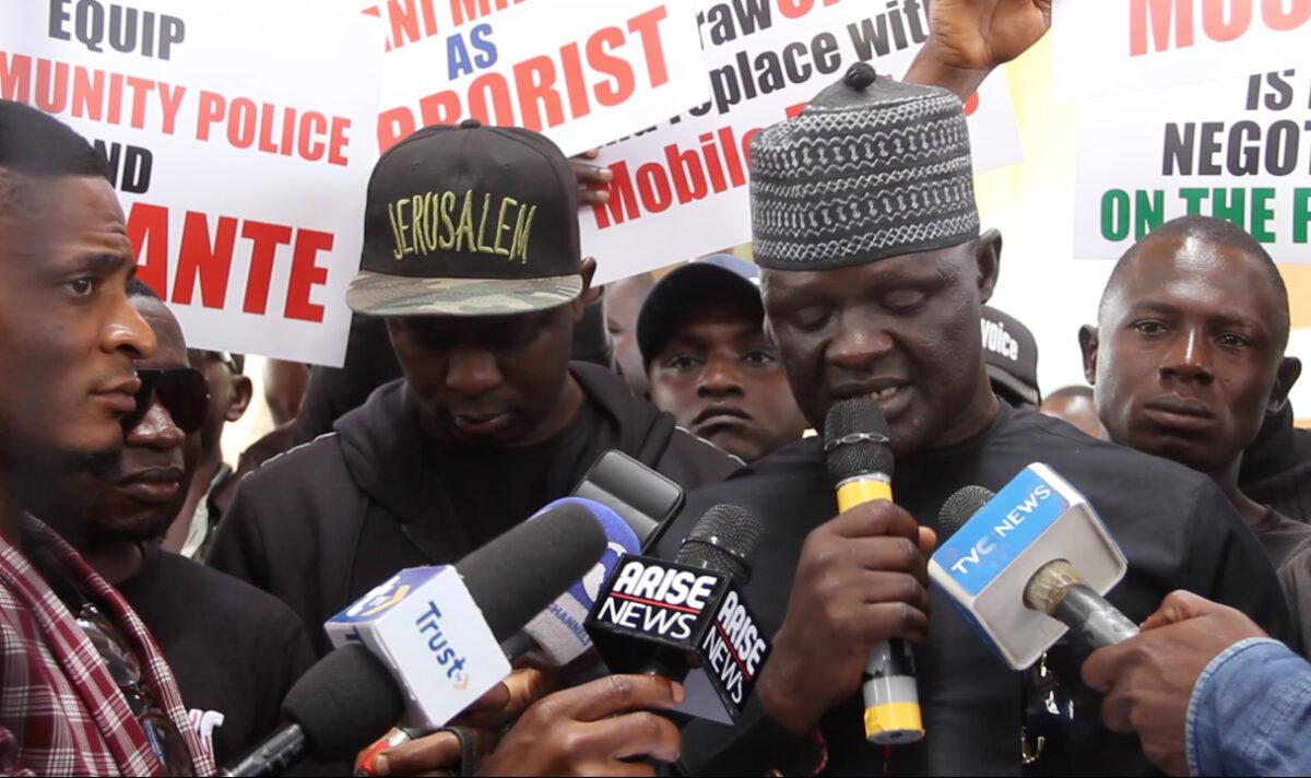 Lot Adas, Plateau state youth leader leads a protest against President Muhammadu Buhari. (Masara Kim/The Epoch Times)