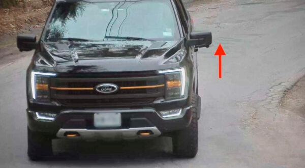 Screenshot of security camera footage showing screws being thrown from the window of a truck. (Courtesy of Dragon Springs)