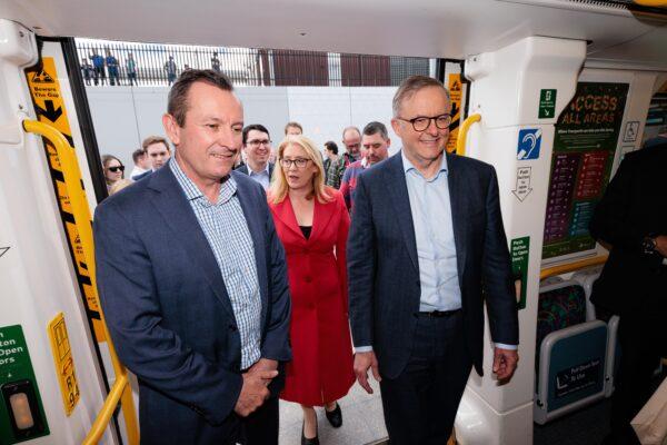 Prime Minister Anthony Albanese, retiring WA Premier Mark McGowan and Transport Minister Rita Saffioti board the first train during the opening of the METRONET Airport Line at High Wycombe Train Station in Perth, Australia, on Oct. 8, 2022. (AAP Image/Richard Wainwright)