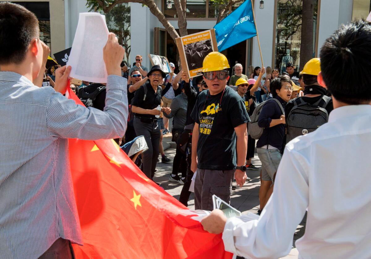 Chinese counter-protesters wave the Chinese flag as members of the US Hong Kong community protest against what they say is police brutality during the ongoing Hong Kong protests, in Santa Monica, Calif., on Aug. 17, 2019. (Mark Ralston/AFP via Getty Images)