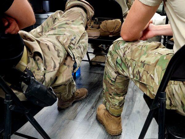 Two male students listen to the day's lesson at Arizona Tactical Adventures in Phoenix on June 3, 2023. (Allan Stein/The Epoch Times)