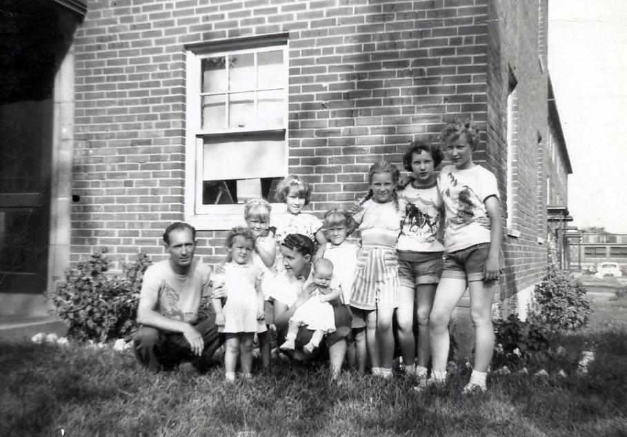 (L-R): Robert Lane (39), Kay (2), Lucy Lane (33), Barbara (3 months), Mickey (6), Bobby (9), Vicky (6), Annie (10), Ellen (15), Ruth (16), and Laverne in Dillon Drive, St. Louis in 1951. (Courtesy of Barbara Lane)