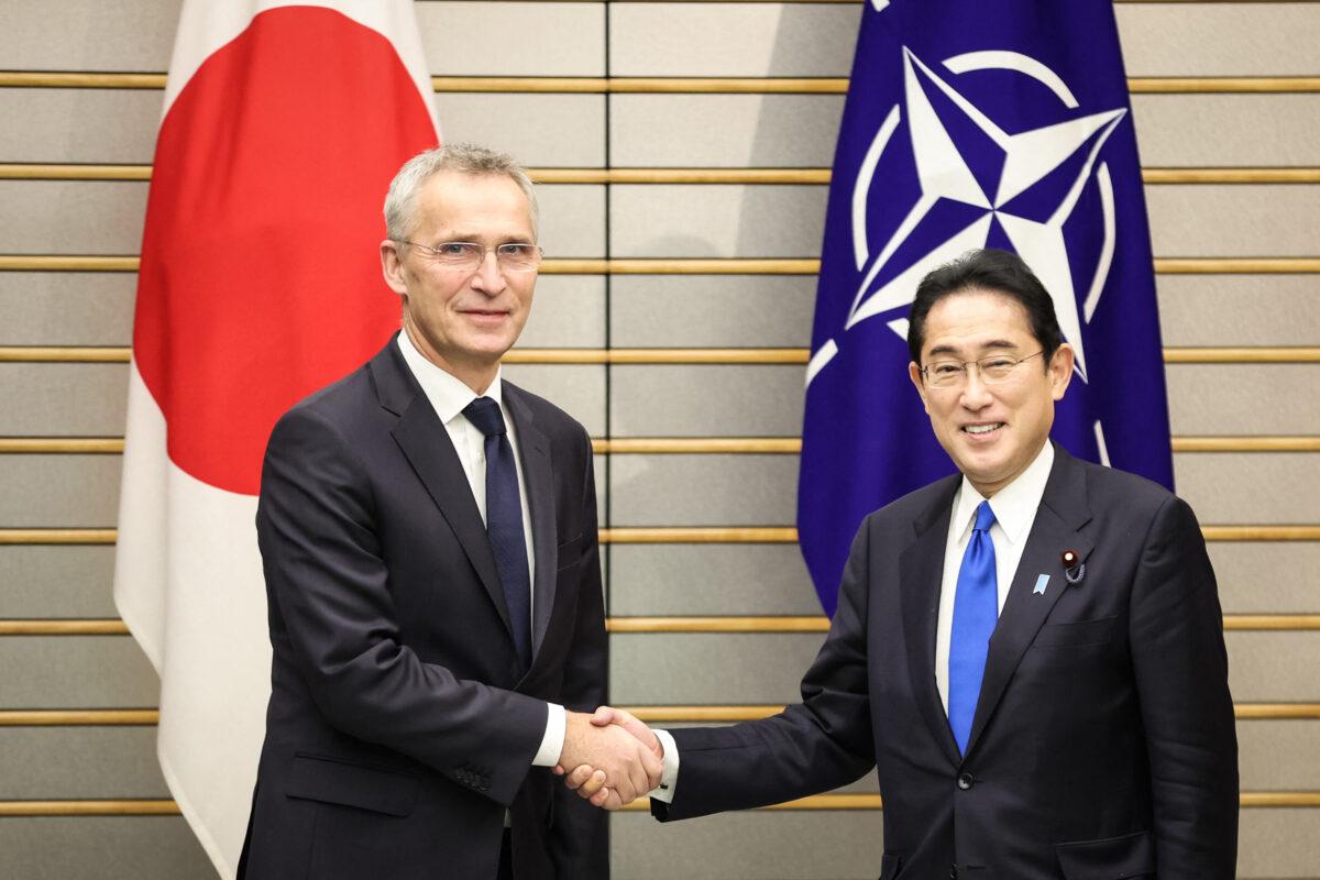NATO Secretary General Jens Stoltenberg (L) shakes hands with Japanese Prime Minister Fumio Kishida in Tokyo on Jan. 31, 2023. (Takashi Aoyama/AFP via Getty Images)