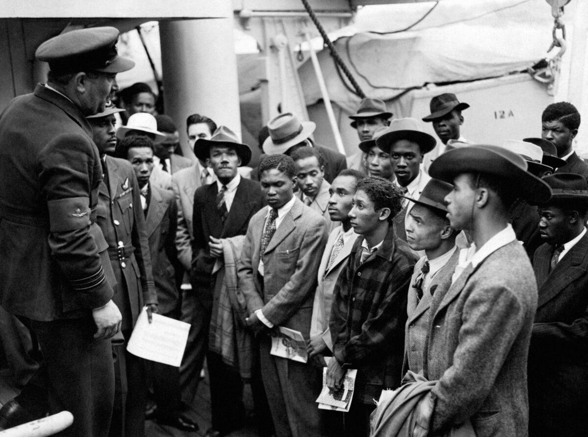 Jamaican immigrants welcomed by RAF officials from the Colonial Office after the ex-troopship HMT 'Empire Windrush' landed them at Tilbury, England, on June 22, 1948. (PA)