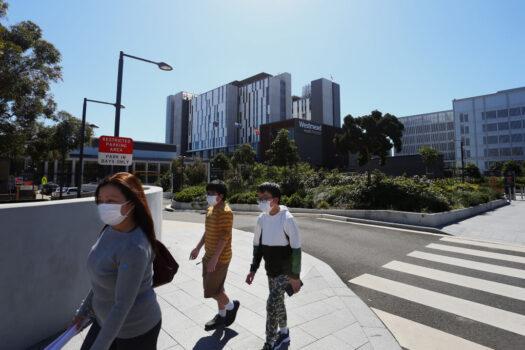 People are seen walking past the main entrance of Westmead Hospital in Sydney, Australia, on Sept. 8, 2021. (Lisa Maree Williams/Getty Images)