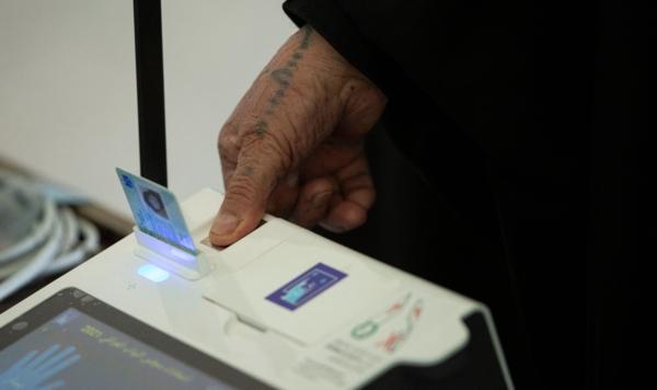 An elderly woman applies her fingerprint as she prepares to vote at a polling station in Basra, Iraq, on Oct. 10, 2021. (Hussein Faleh/AFP via Getty Images)