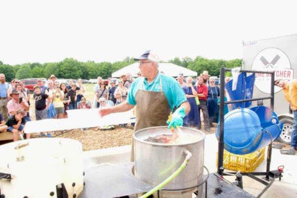 Joel Salatin, owner of Polyface Farm, holds a chicken butchering class at the Food Independence Summit. (Courtesy of Everitt Townsend)
