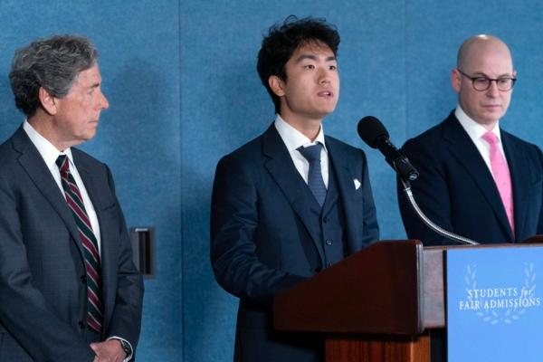 Berkeley University student Calvin Yang (C), flanked by Edward Blum (L) and Adam Mortaraw, speaks during a news conference on the Supreme Court's affirmative action in college admissions decision at the Press Club in Washington on June 29, 2023. (Jose Luis Magana/AP Photo)