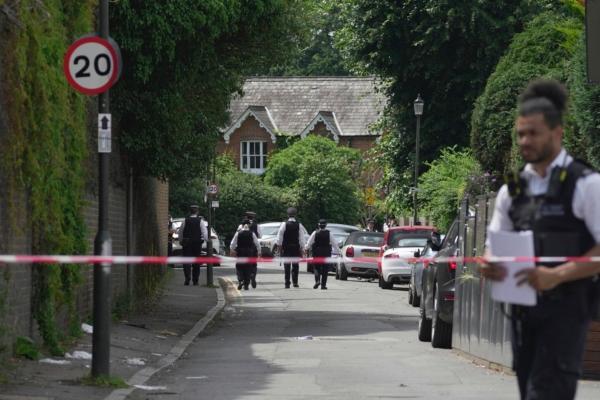Police officers set up a cordon line after a car crashed into a primary school building in Wimbledon, London, on July 6, 2023. (Kin Cheung/AP Photo)