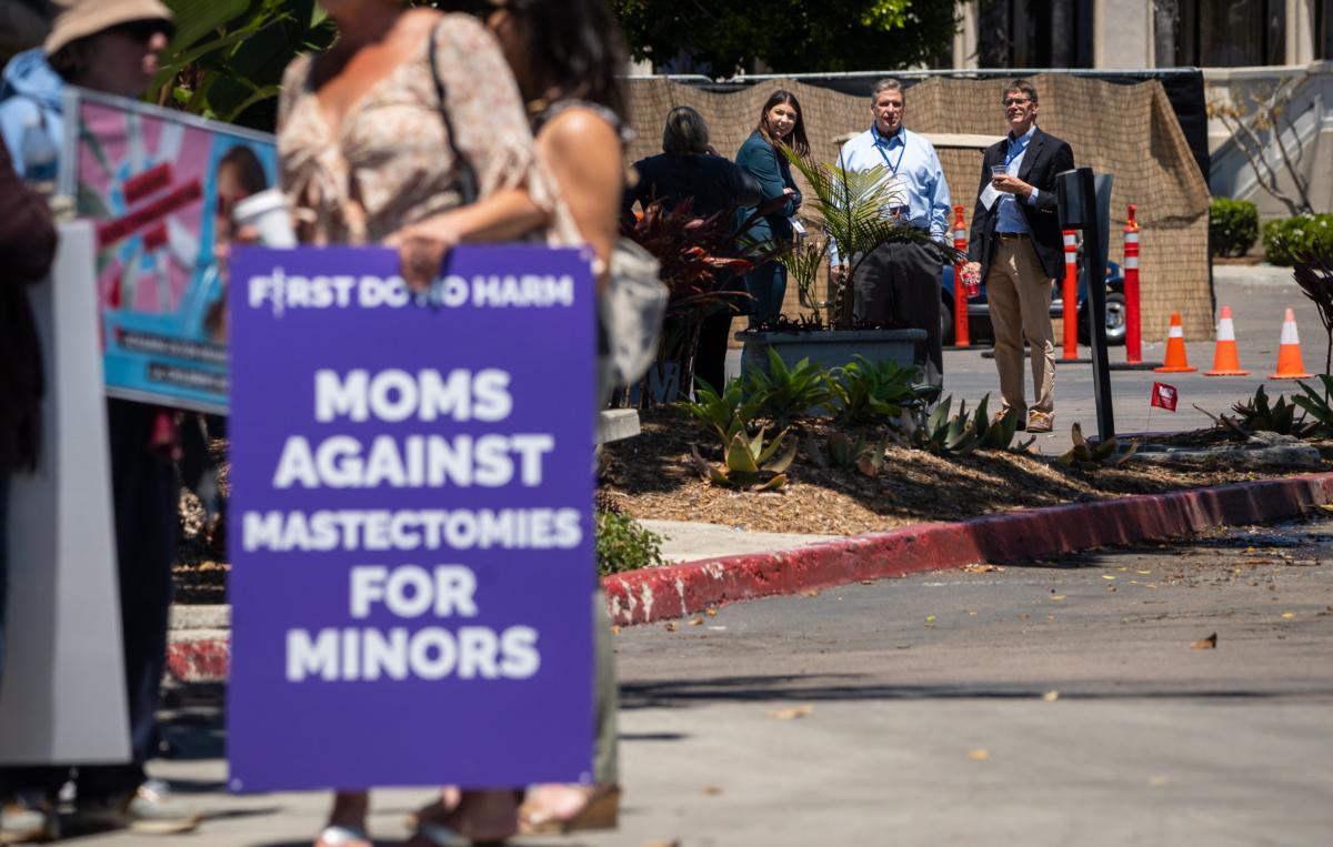 Medical professionals attending the annual Pediatric Endocrine Society conference listen to detransition advocates as they use intercom's in San Diego, Calif., on May 6, 2023. (John Fredicks/The Epoch Times)