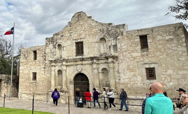 Tourists gather in front of the chapel of the Alamo Mission, known as the "Shrine of Texas Liberty," in downtown San Antonio, Texas, on January 23, 2023. (Daniel Slim/AFP via Getty Images)